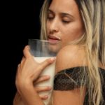 woman holding glass of milk
